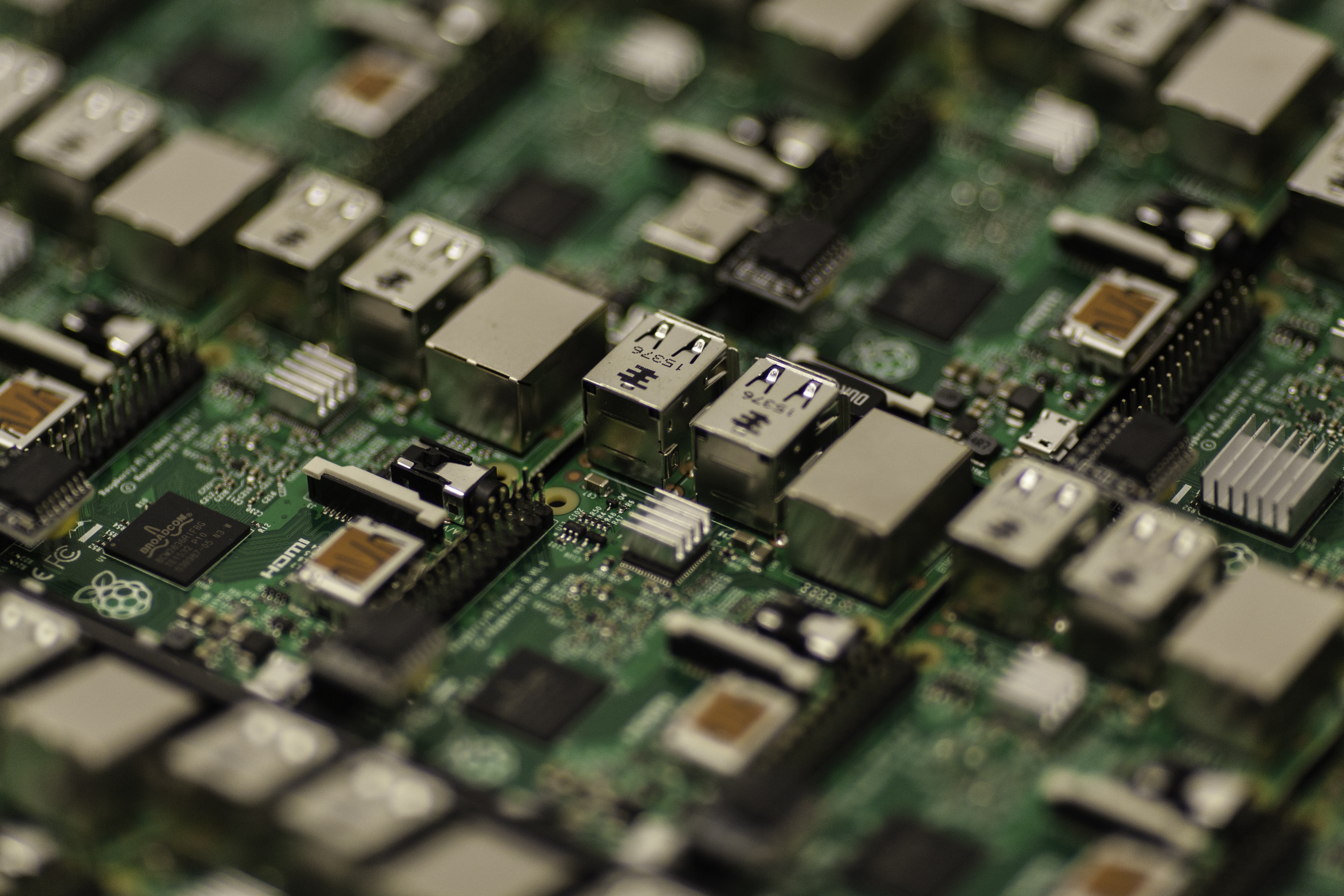 Close-up view of multiple electronic circuit boards with USB ports and integrated components used in embedded systems and EMI filtering applications.